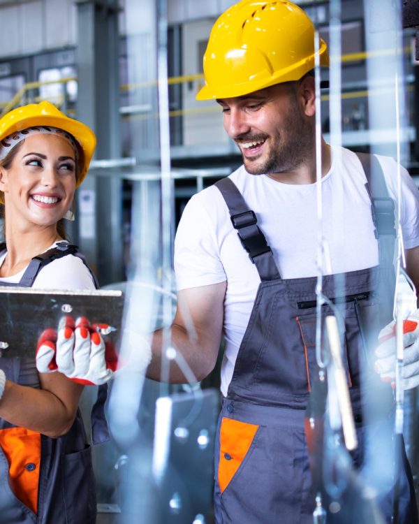 factory-workers-working-together-industrial-metal-production-line